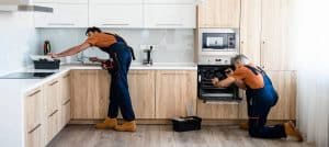 Deep cleaning team cleaning kitchen countertops for property maintenance.