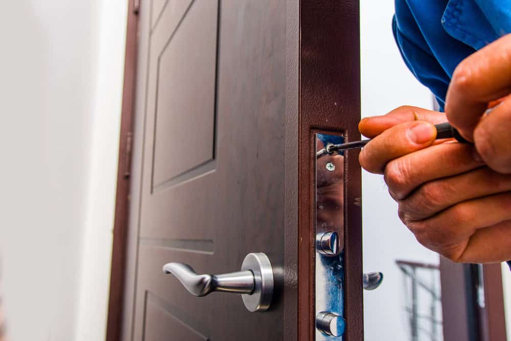 Workman fixing the door lock